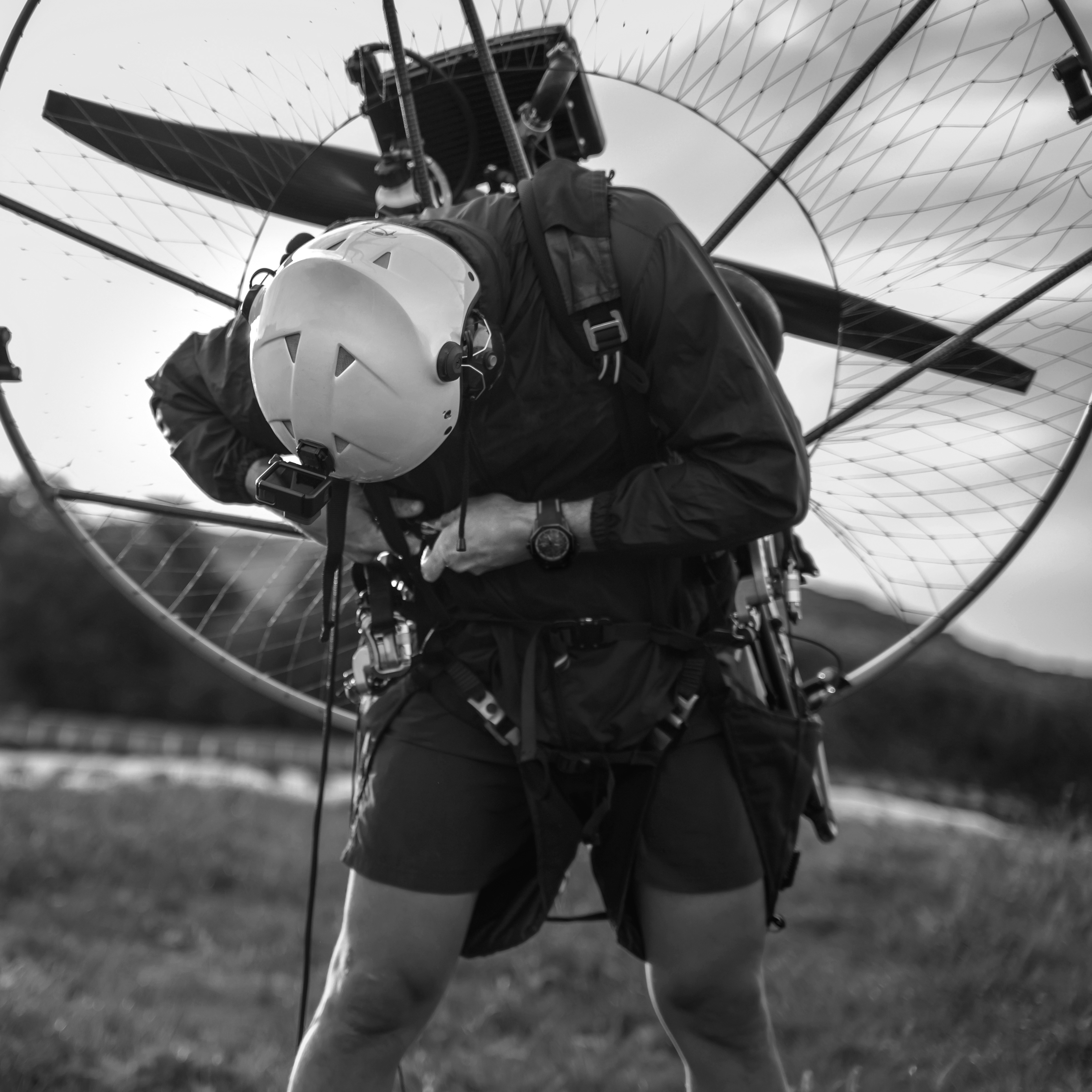 Young man, wearing a white helmet with an Action Cam on it, gets